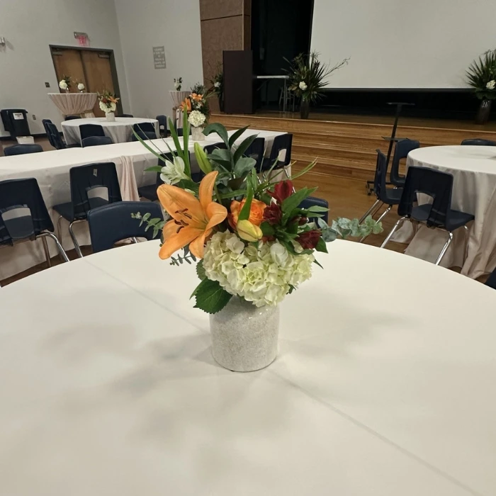 Flower arrangements are set on each table. Flower arrangements are set on each table.